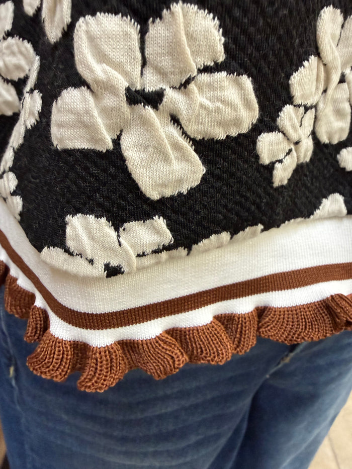 Black floral embossed knit sleeve with raised flower print and ribbed striped cuff