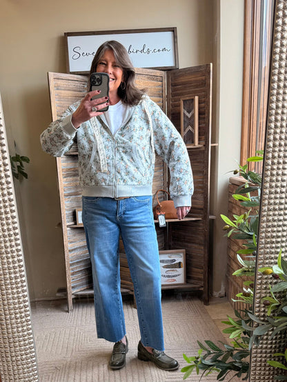Floral zip-front hoodie in mint with cream trim, standing collar and long sleeves