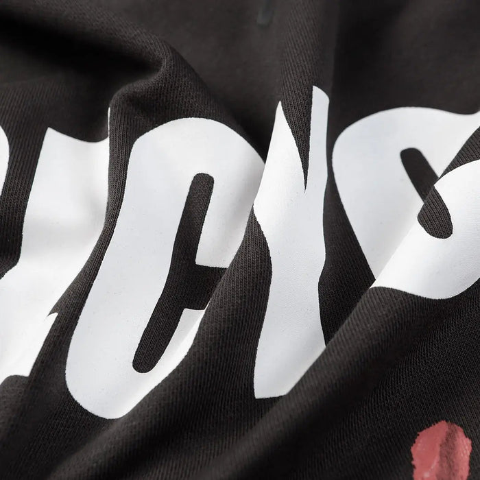 Black hoodie fabric close-up with large white RECYCLE lettering