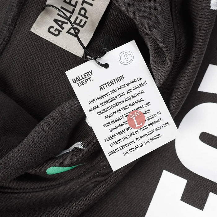Black hoodie inside view with hanging size and care label at neckline