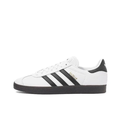 Adidas Gazelle Indoor sneakers in white with black stripes and black heel tab