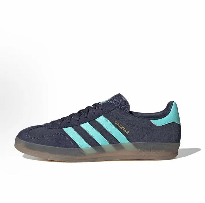 Adidas Gazelle Indoor lace-up sneaker in dark navy with turquoise 3-Stripes and gum sole.