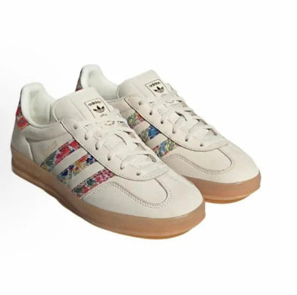 Adidas Gazelle Indoor sneakers with cream uppers, multicolor stripes, and gum sole