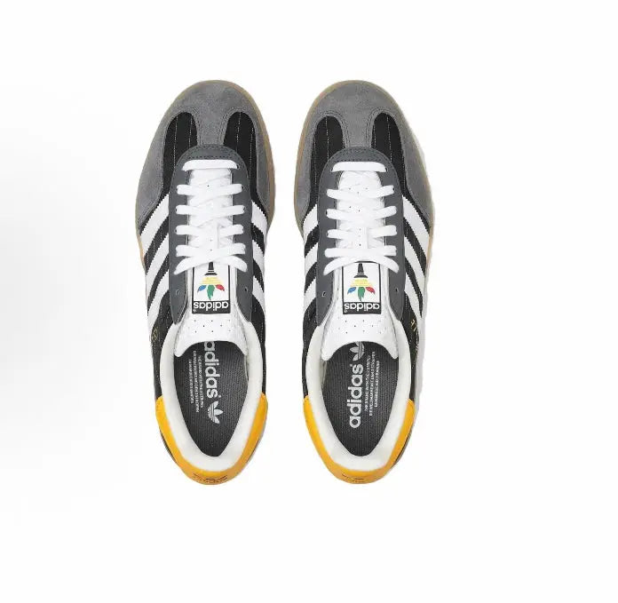 Adidas Gazelle indoor sneakers pair, black uppers, white laces, gum soles