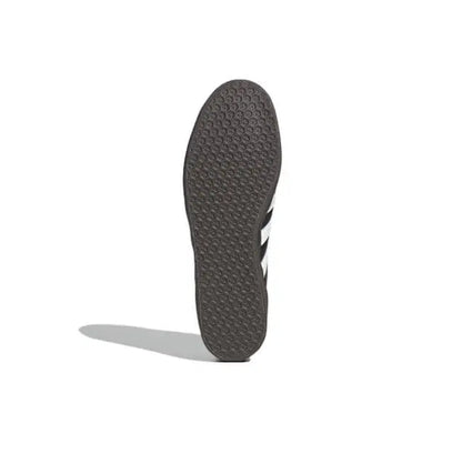 Gazelle indoor sneakers outsole, dark textured tread with white stripe accents