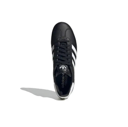Gazelle indoor sneakers front view, black upper with white stripes and lace-up