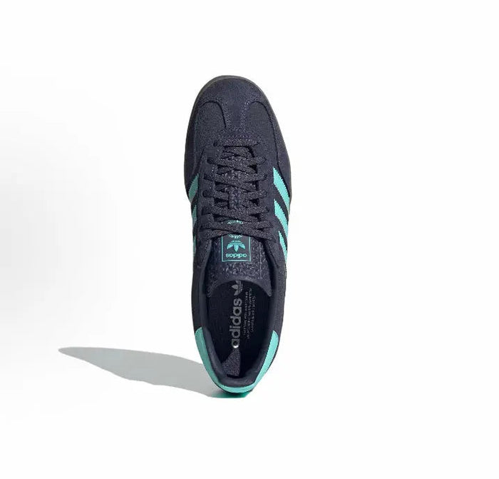 Adidas Gazelle Indoor sneaker with dark navy upper, lace-up front, turquoise 3-Stripes.