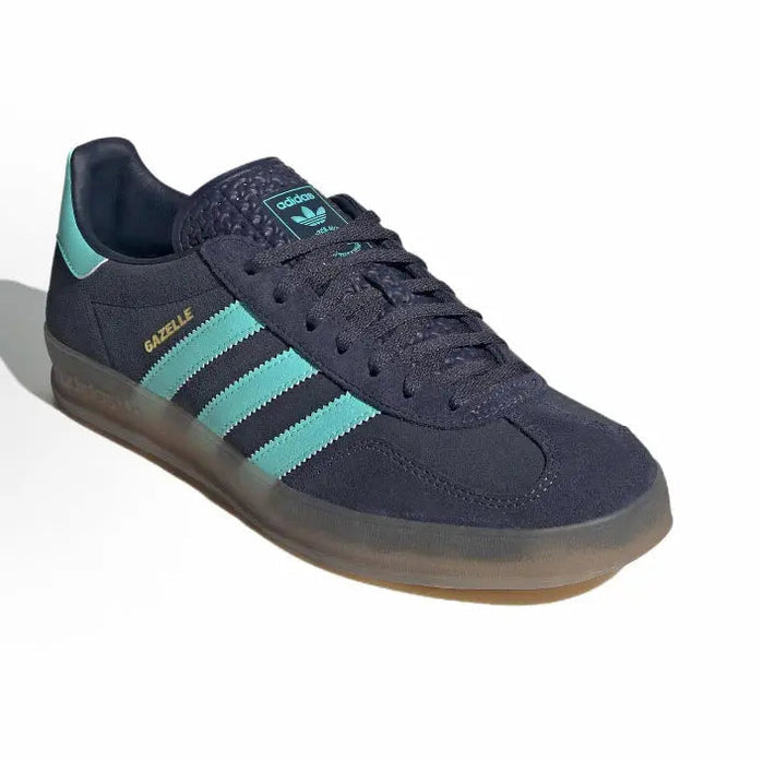 Adidas Gazelle Indoor lace-up sneaker in dark navy with turquoise 3-Stripes and gum rubber sole.