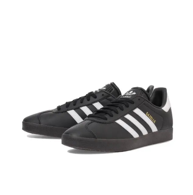 Gazelle indoor sneakers pair, black with white triple stripes and lace-up