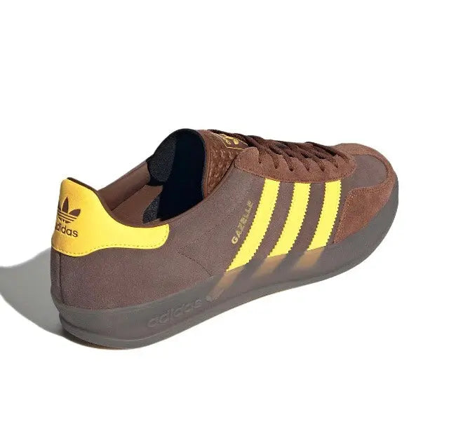 Adidas Gazelle Indoor sneakers with yellow heel tab and suede-style brown upper