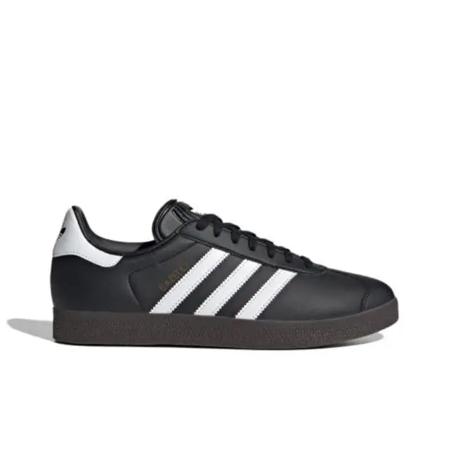 Gazelle indoor sneakers side profile, black leather with white stripes and rubber sole