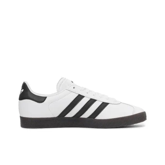 Gazelle Indoor sneakers, side view in white with black stripes and dark rubber sole