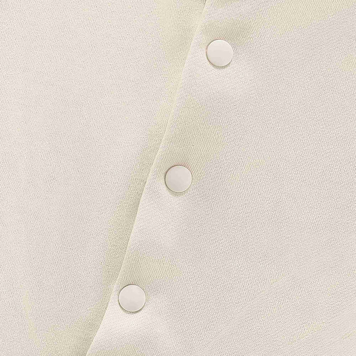 Beige hoodie fabric close-up with three round snap buttons on placket