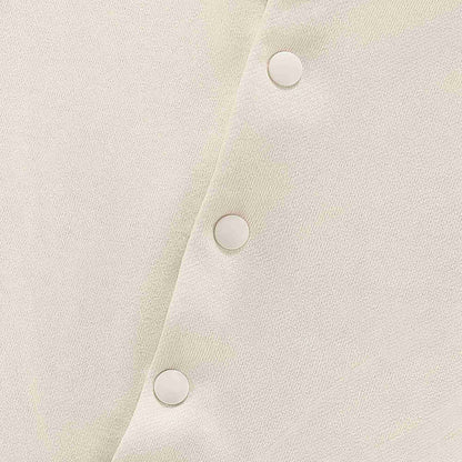 Beige hoodie fabric close-up with three round snap buttons on placket
