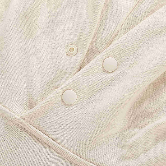 Beige fabric detail with snap buttons on the hood opening placket.