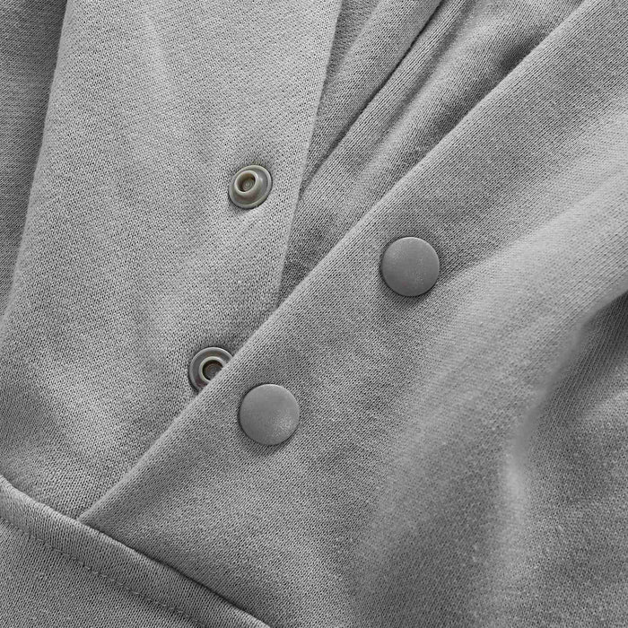 Grey hoodie neckline with snap buttons and placket detail.