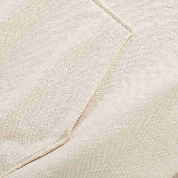 Beige hoodie fabric and sleeve seam detail with smooth knit surface.