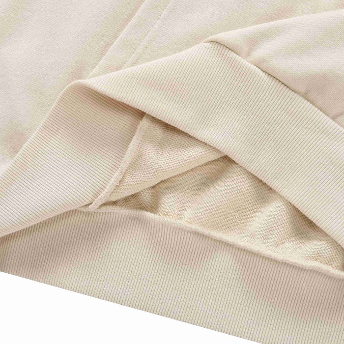 Beige hoodie ribbed cuff and sleeve hem detail with overlapping fabric.