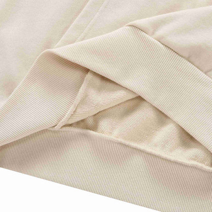 Beige hoodie ribbed cuff and sleeve hem detail with overlapping fabric.