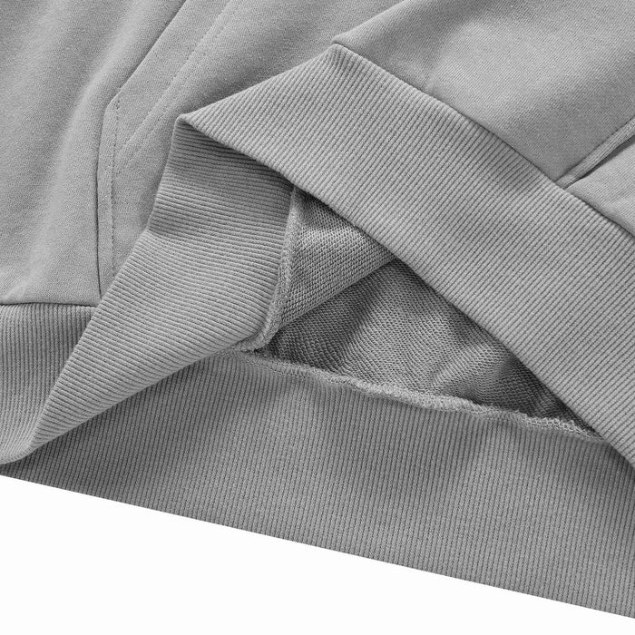 Grey hoodie hem with ribbed trim and overlapped fabric layer detail.