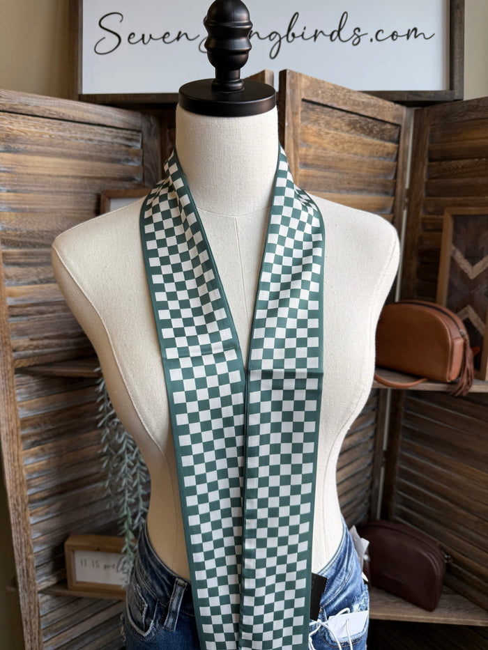Green and white checked twilly scarf hanging down the front on mannequin