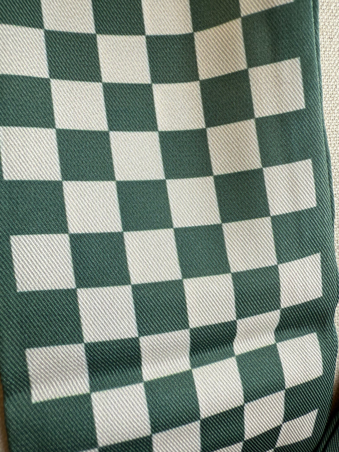 Green and white check pattern twilly scarf fabric close-up