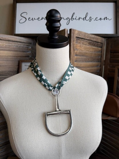 Green and white checked twilly scarf on mannequin with tie ends and metal clasp