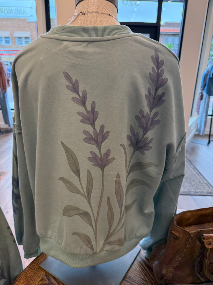 Floral watercolor sweatshirt in muted green with back purple leaf sprig print