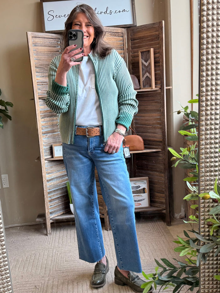 Mint green ribbed zip-front cardigan with long sleeves, worn over light top