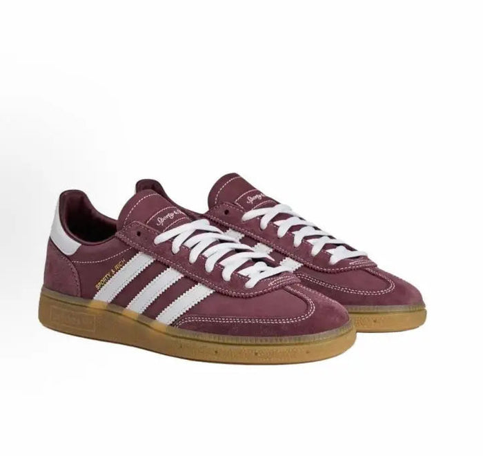 Adidas Handball Spezial sneakers, maroon suede, white stripes, side profile view
