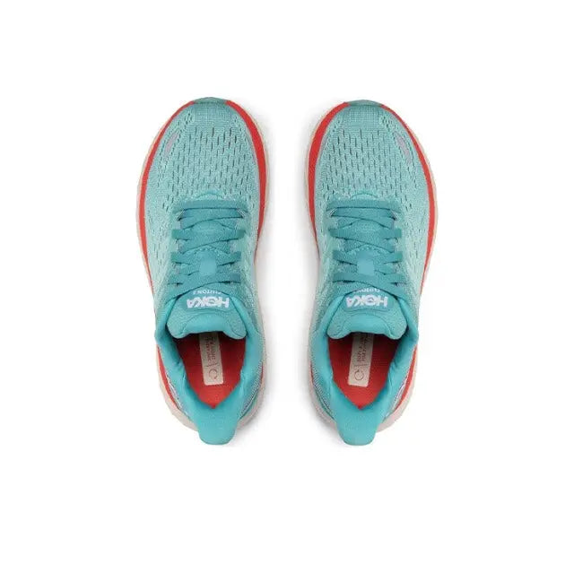 Teal running shoes with red-edged collars and white laces, top view