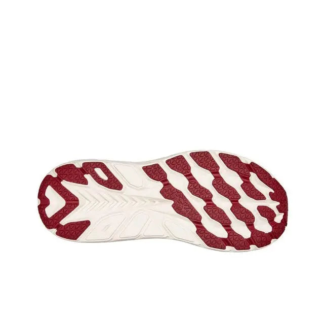 Running shoe outsole, burgundy traction pods on white rubber base