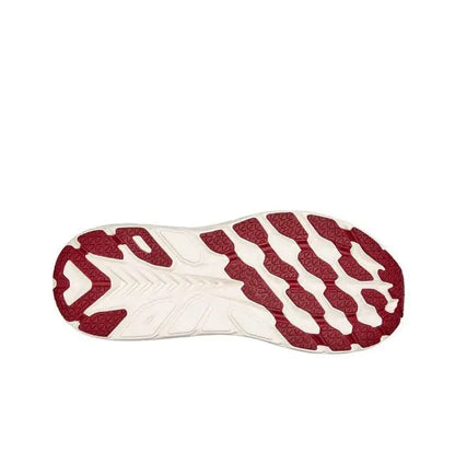 Running shoe outsole, burgundy traction pods on white rubber base