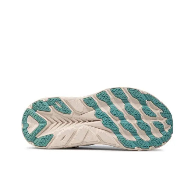 Teal and white outsole with traction tread pattern