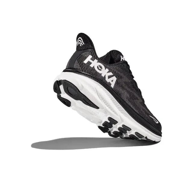 Black HOKA running shoe with lace-up front and white midsole in side profile