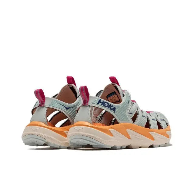 Hoka Hopara athletic shoe heel view with fuchsia pull tab, teal upper, orange midsole accents