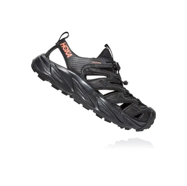 Trail shoe angled view, black with hook-and-loop strap and lace-up closure