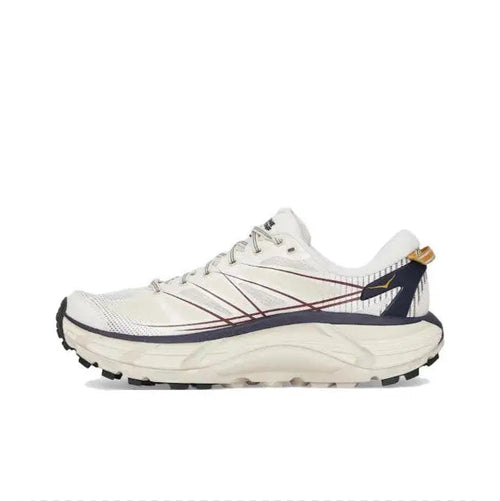 Trail running shoe in light cream with navy overlays, lace-up, rugged tread sole