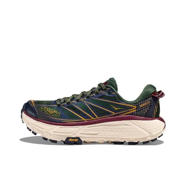 Trail running shoe in dark navy and green with maroon accents and cream sole