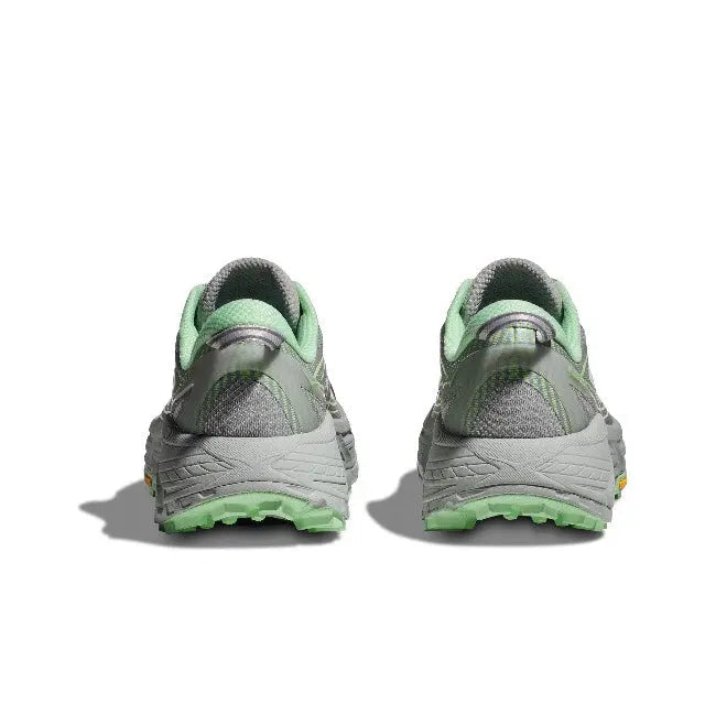Pair of light gray sneakers with green heel collar and chunky tread outsole