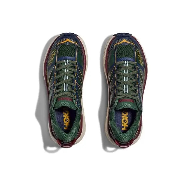 Pair of trail shoes in dark navy and green, cream midsoles and maroon heel trim