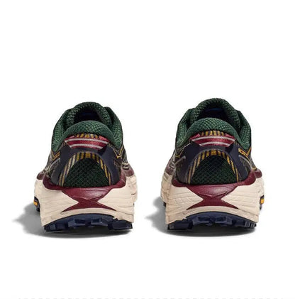 Trail running shoe with green collar, maroon heel pull, cream sole and dark tread