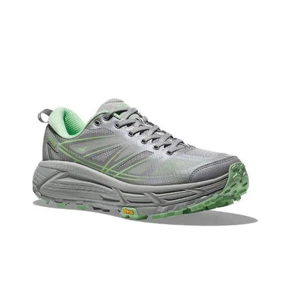 Light gray trail running shoe with green lining, lace-up front, grippy tread