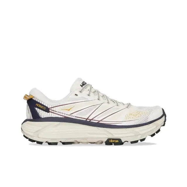 Trail running shoe front/side in light cream with navy trim, lace-up, thick tread