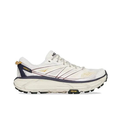 Trail running shoe front/side in light cream with navy trim, lace-up, thick tread