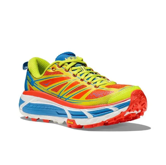 Trail running shoe 3/4 front view with bright multi-color upper and red outsole