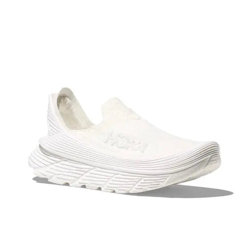 Hoka Restore TC slip-on running shoe, white knit upper and cushioned ridged sole.