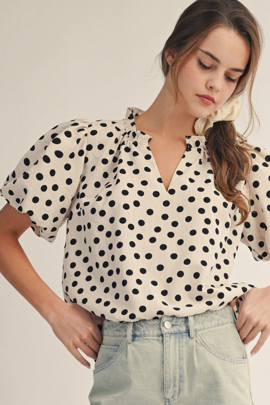 Ivory V-neck polka dot shirt with short puff sleeves and black dot pattern
