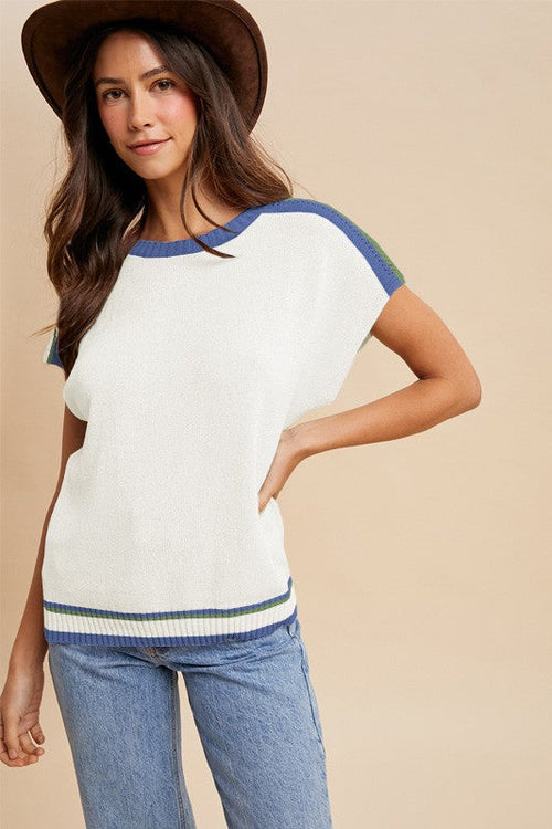 Ivory sleeveless colorblock sweater with blue neckline, arm bands, and hem trim