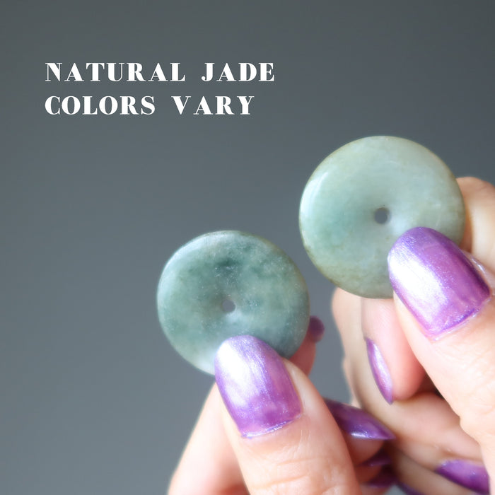 hand holding jade donut amulets